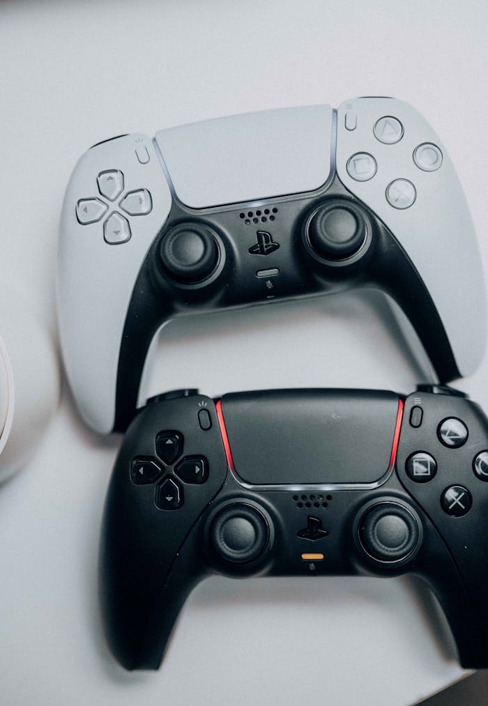 DualSense controllers of PlayStation 5 in black and white close-up on a white background.